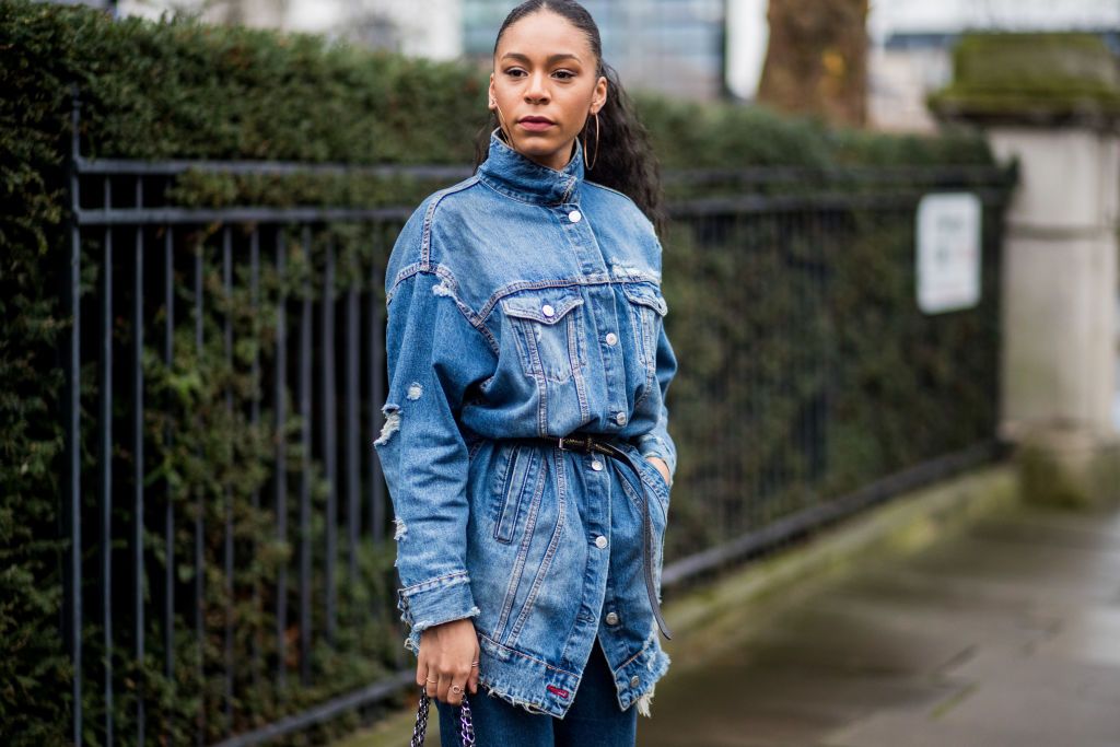 Premium Photo | Fashion beautiful woman model in a black stylish denim  jacket with rhinestones in denim shorts and a black top posing in the city